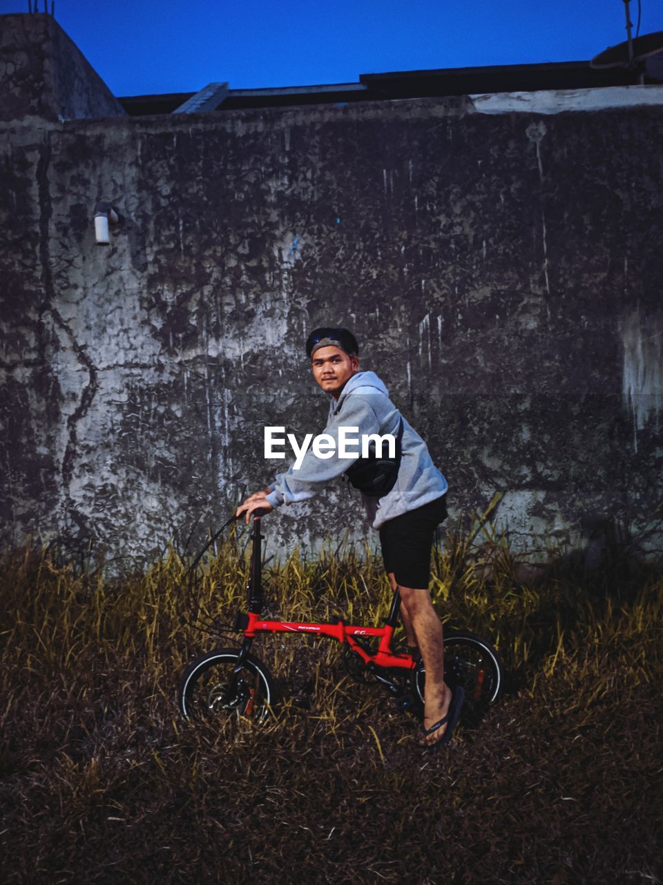 Portrait of man riding bicycle on field