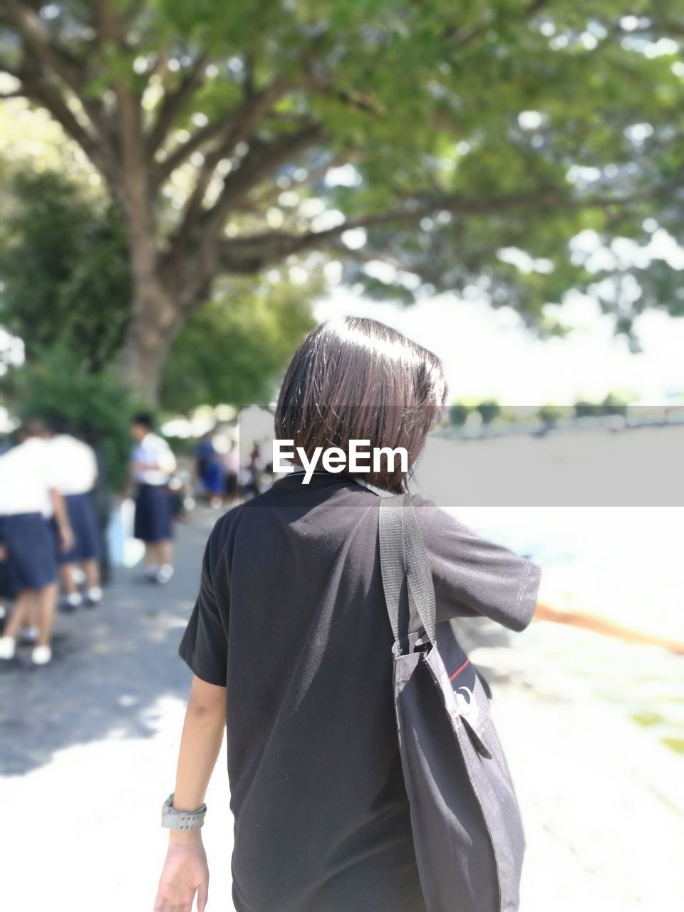 REAR VIEW OF WOMAN WITH UMBRELLA ON BACKGROUND