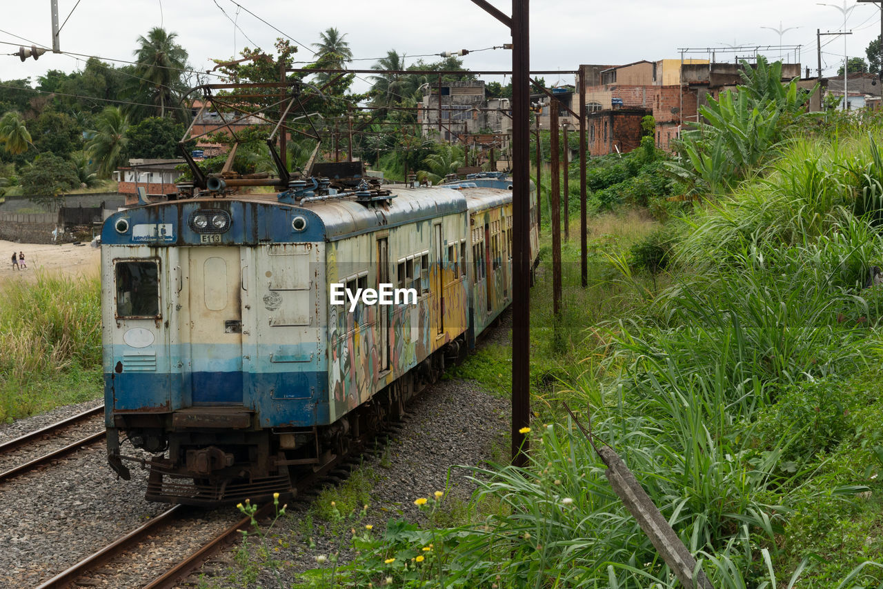 rail transportation, transportation, track, mode of transportation, railroad track, train, vehicle, public transportation, transport, rolling stock, plant, railway, nature, locomotive, land vehicle, architecture, travel, no people, railroad car, sky, tree, day, outdoors, electricity, grass