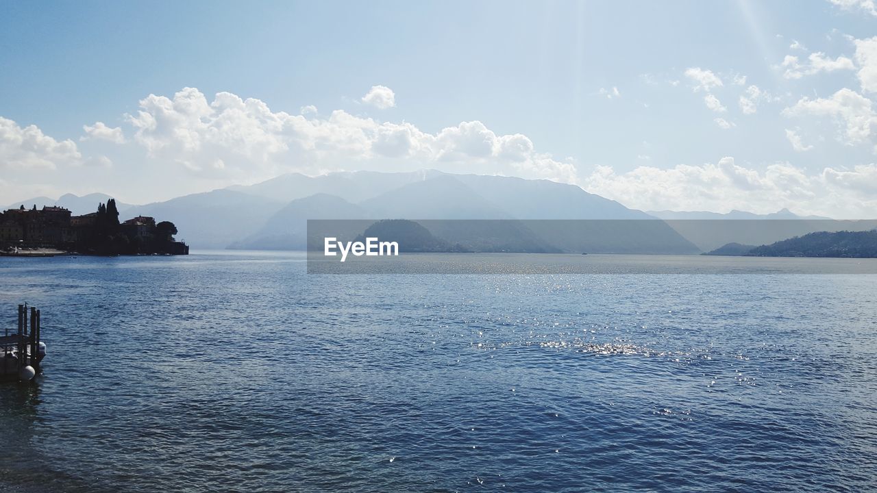 SCENIC VIEW OF SEA BY MOUNTAIN AGAINST SKY