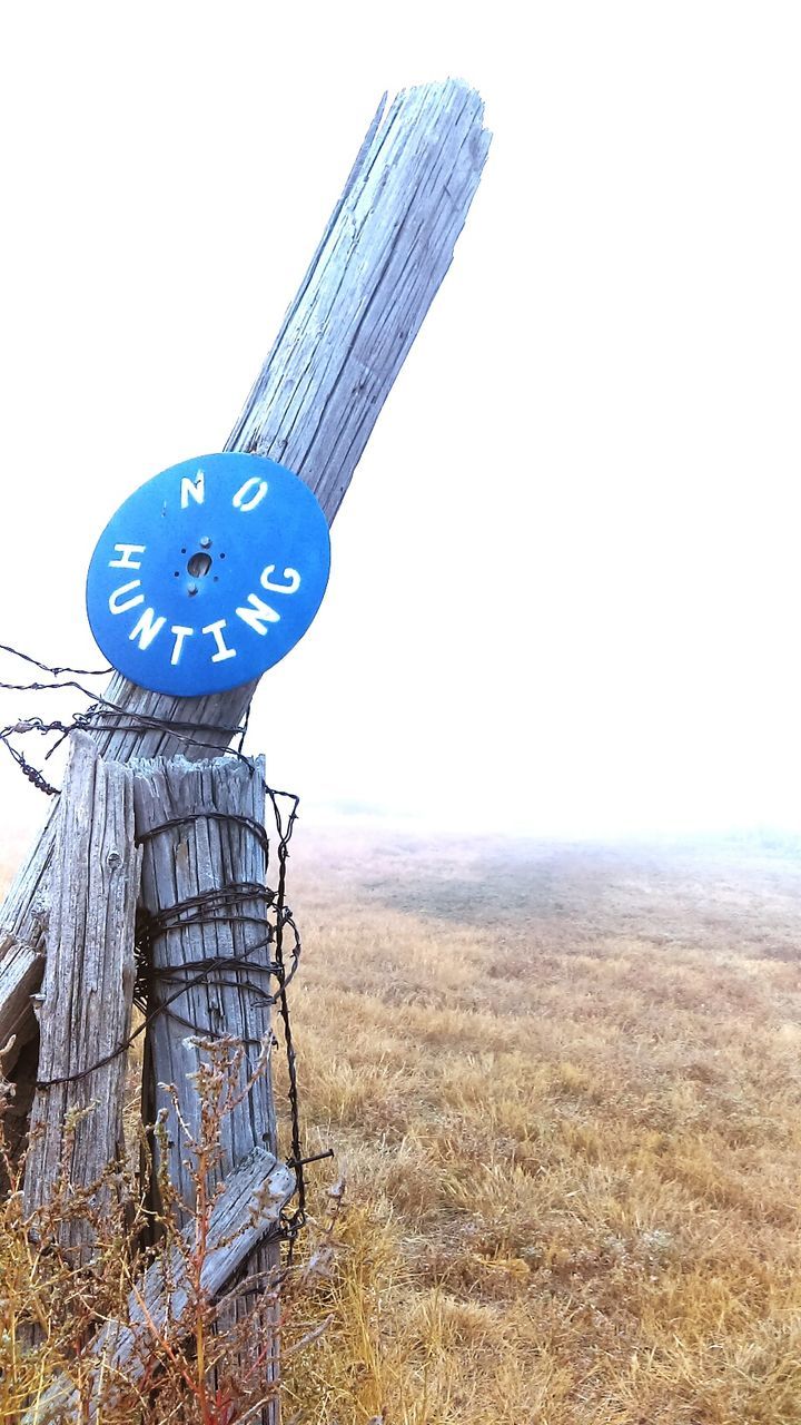 TELEPHONE POLE AGAINST CLEAR SKY