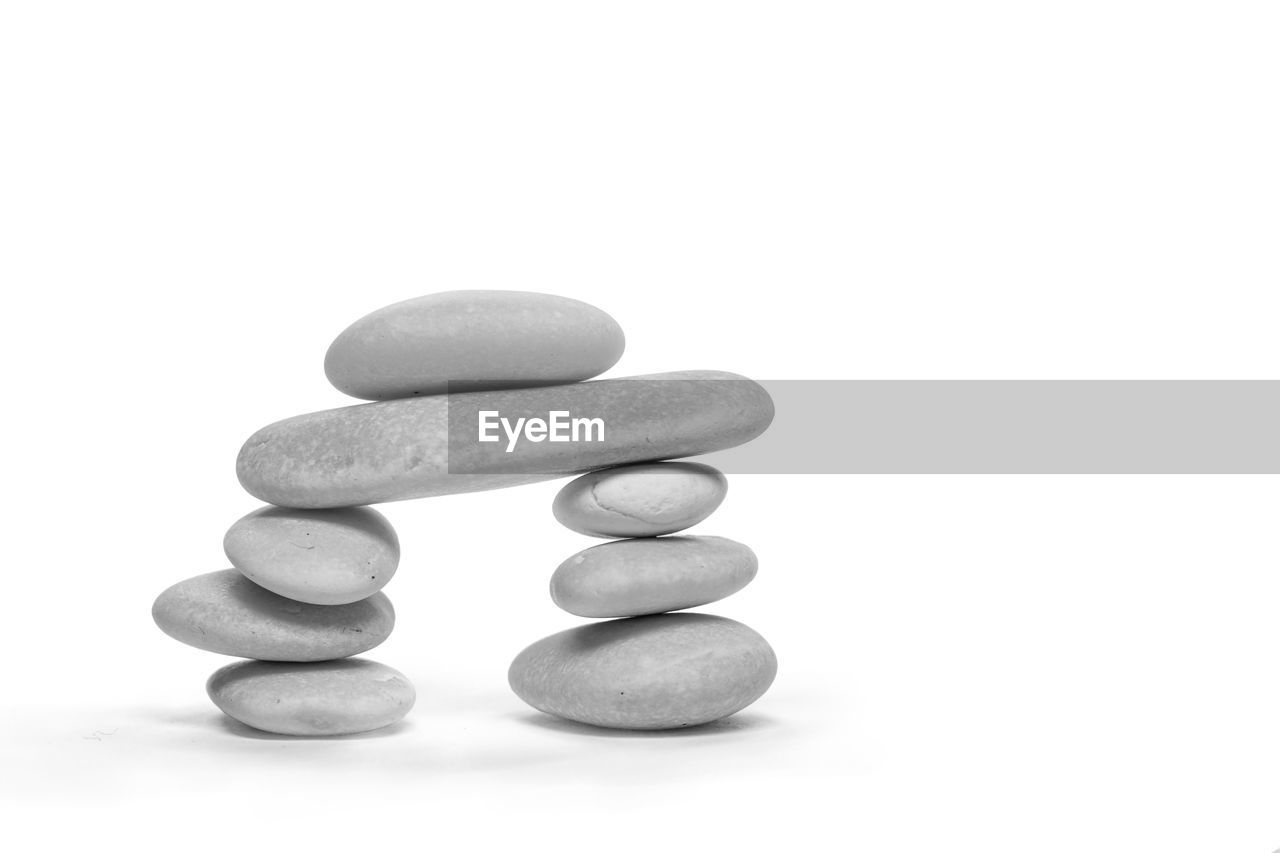 Close-up of pebbles against white background