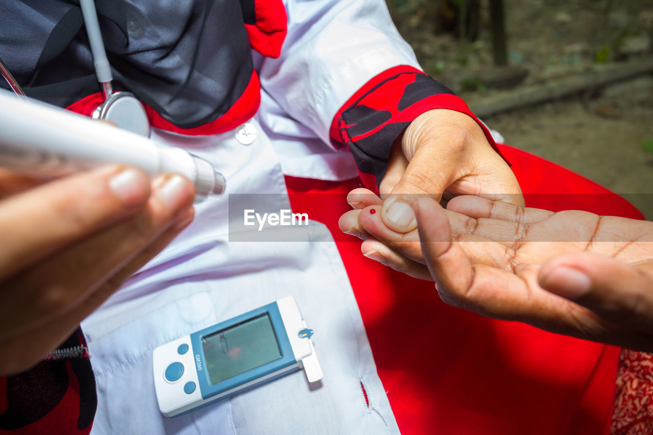 High angle view of woman checking diabetes