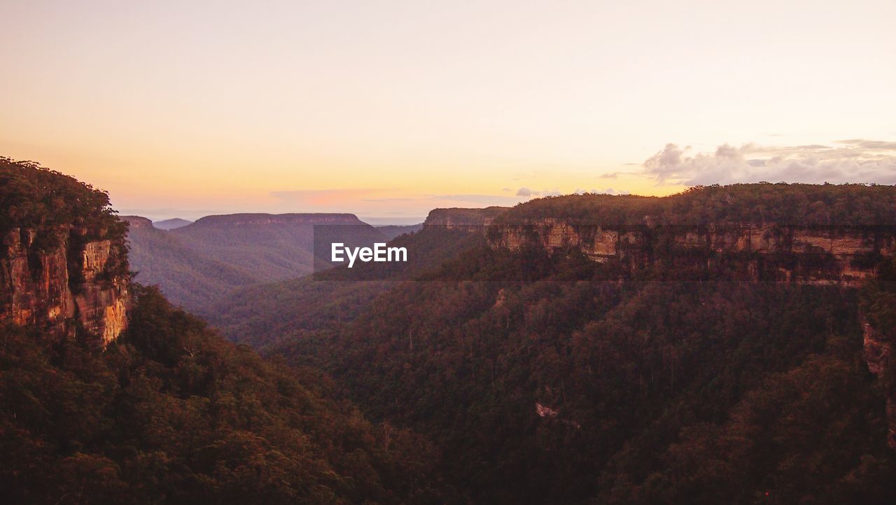 SCENIC VIEW OF LANDSCAPE AT SUNSET