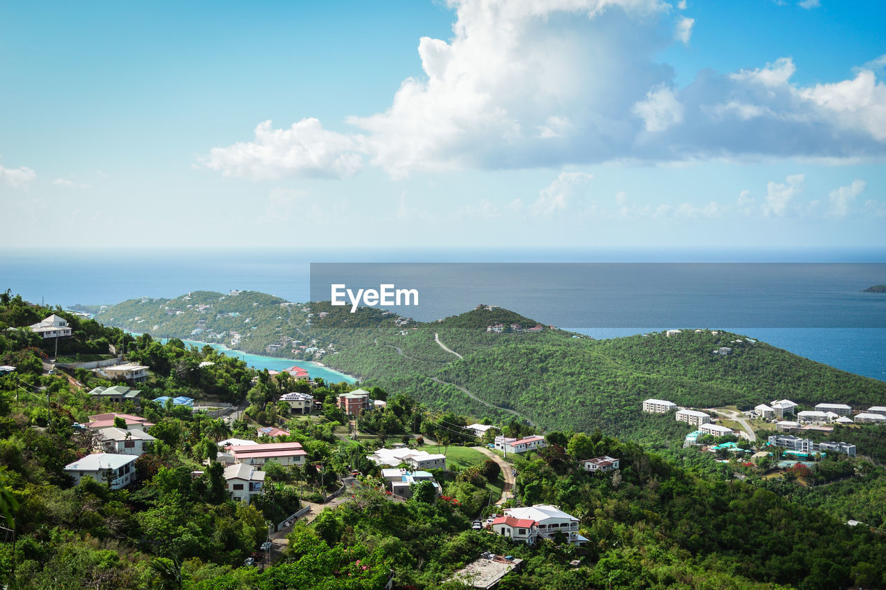 High angle view of buildings and sea against sky