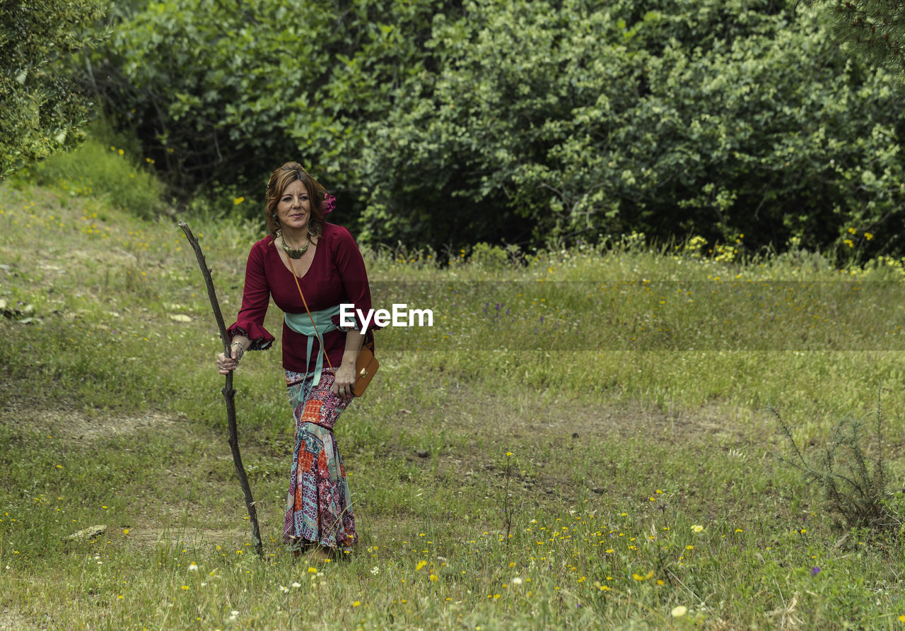 Full length of woman walking on grassy land