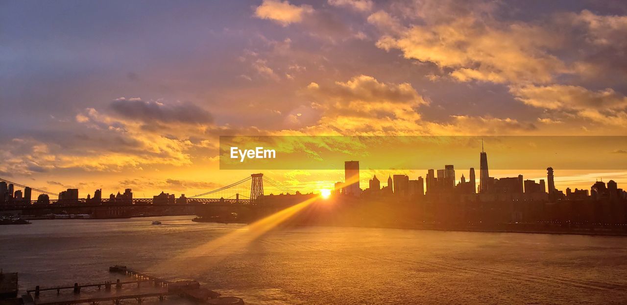 Scenic view of buildings against sky during sunset