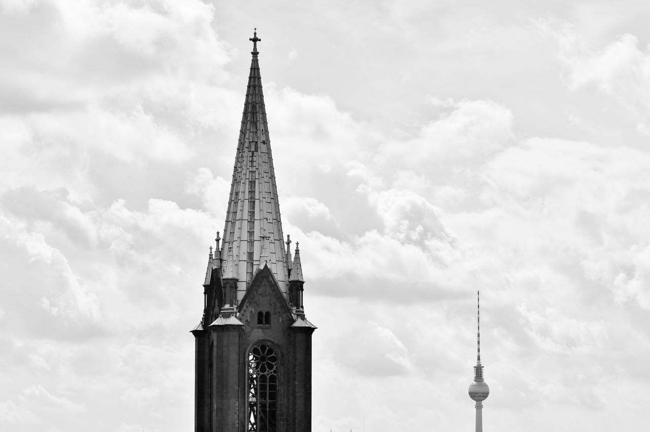 St mary church and fernsehturm against cloudy sky