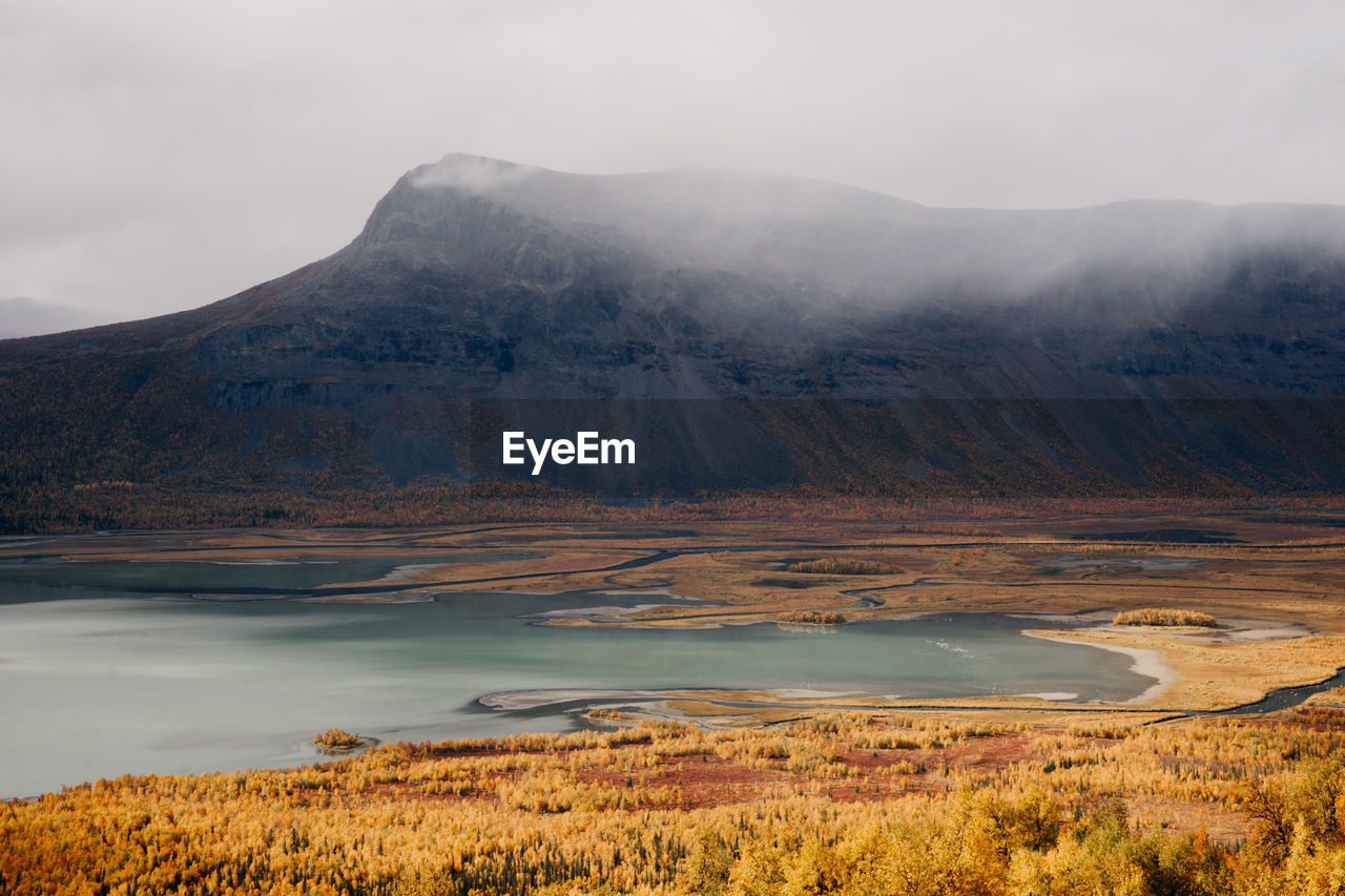 Scenic view of lake and mountains against sky