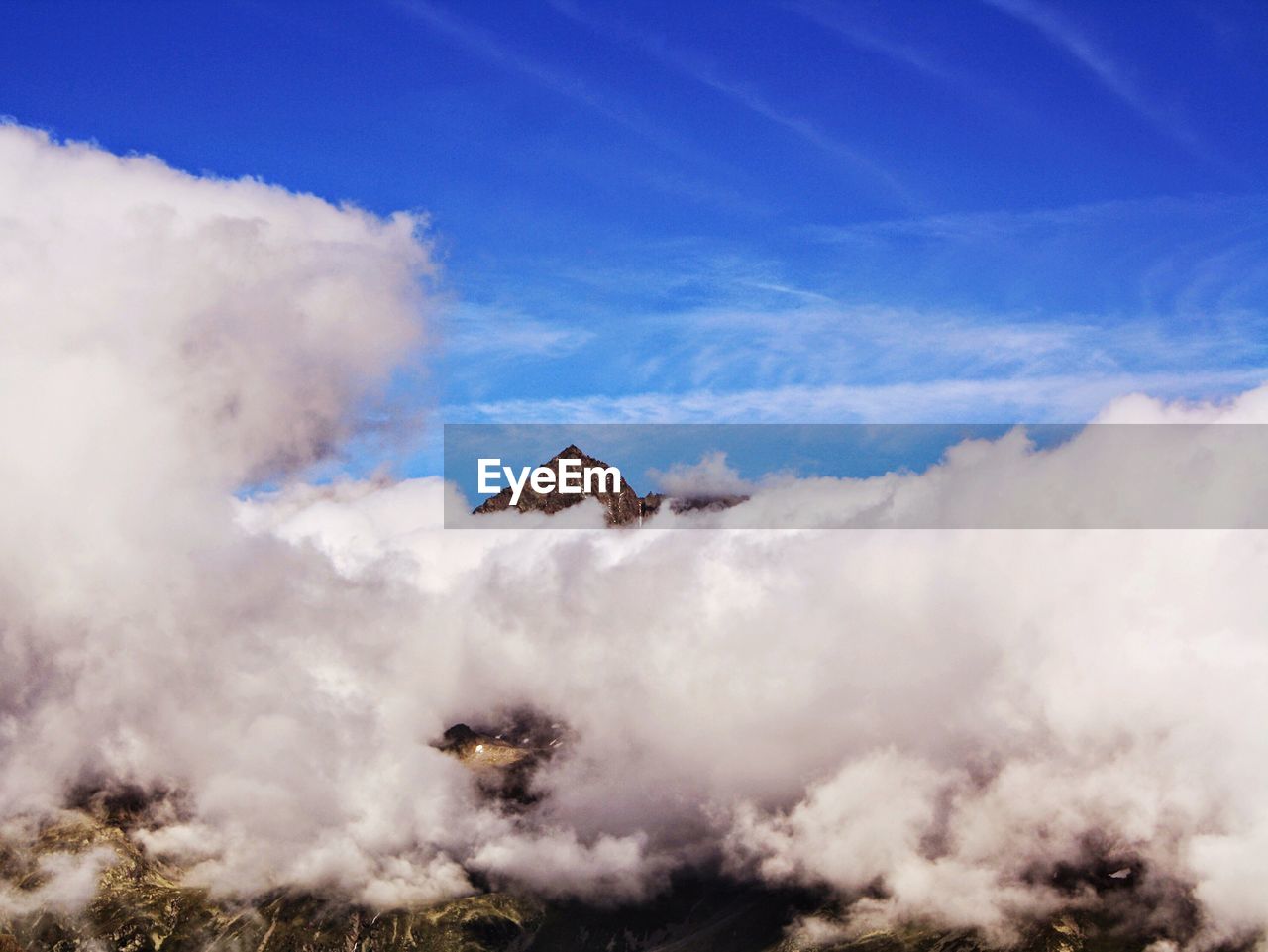 SCENIC VIEW OF CLOUDS OVER MOUNTAIN