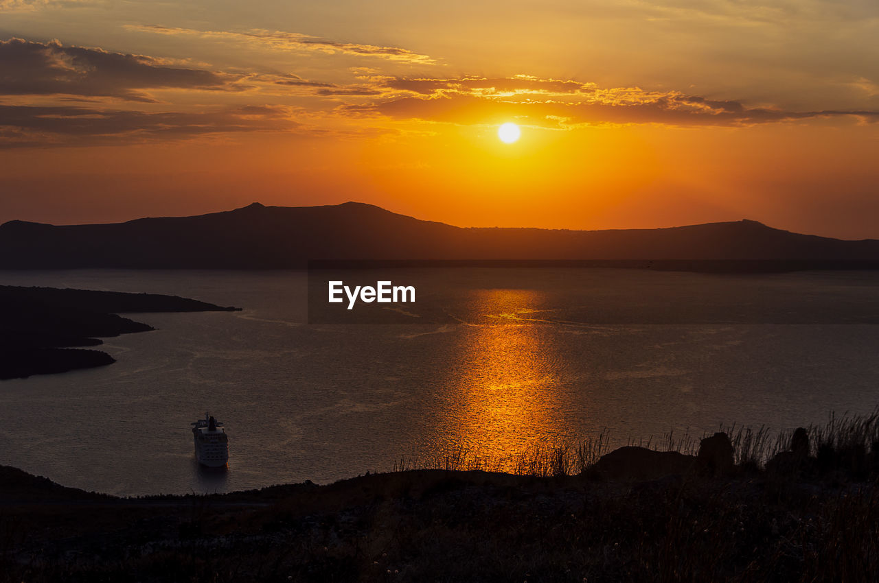 Evening view of caldera, volcano of santorini, greece with cruise ships at sunset. 