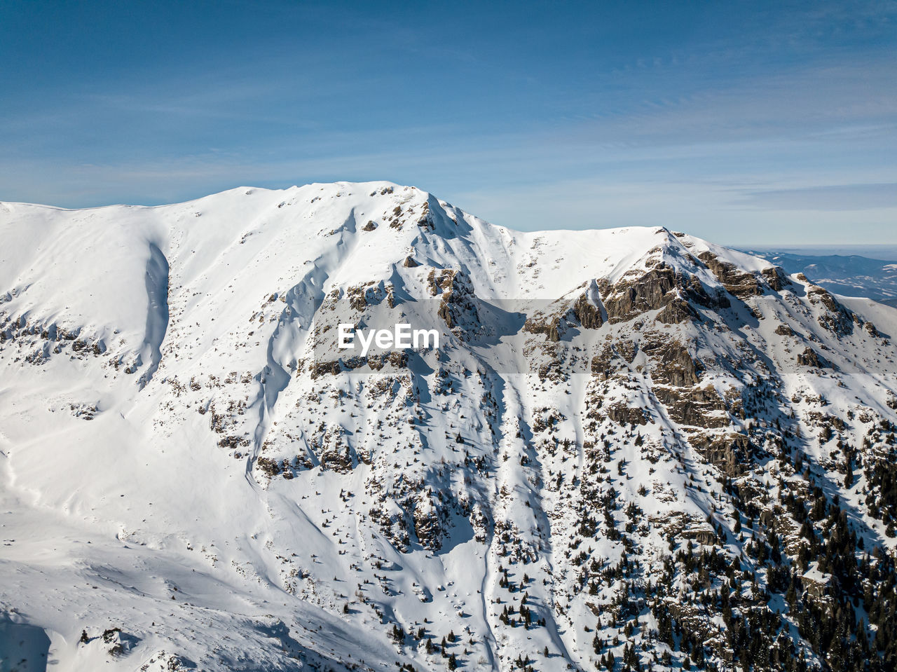 Snowy mountain valley, at high altitude, dangerous place for hiking or skiing