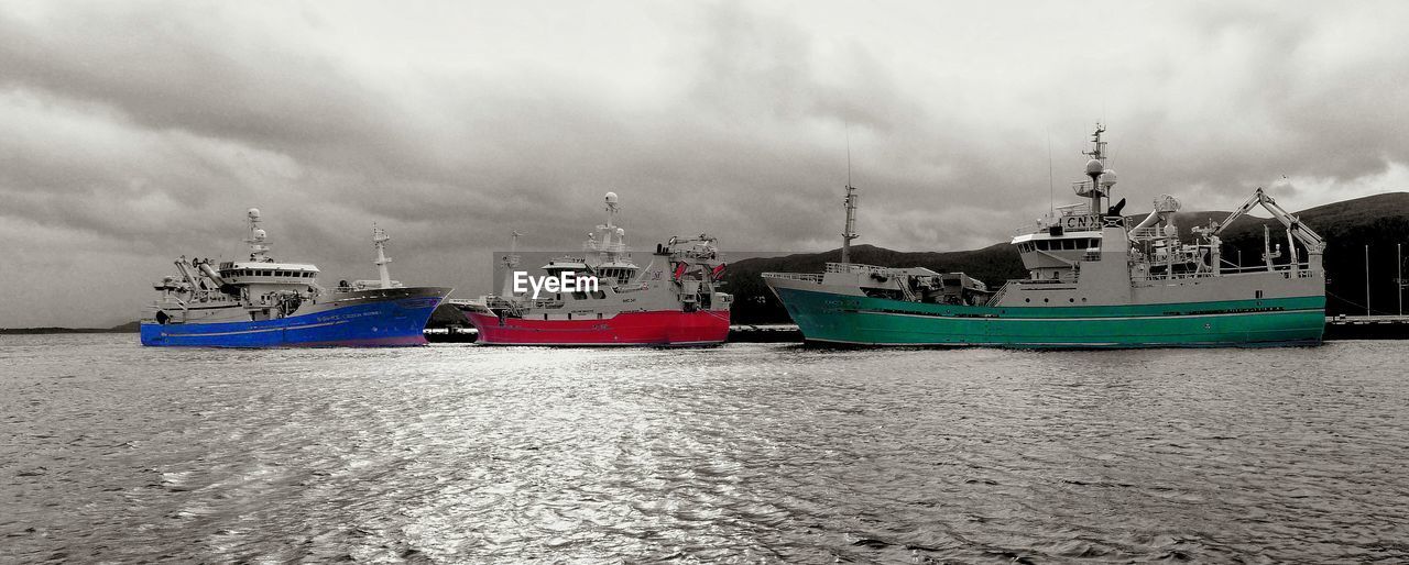 BOATS MOORED IN HARBOR