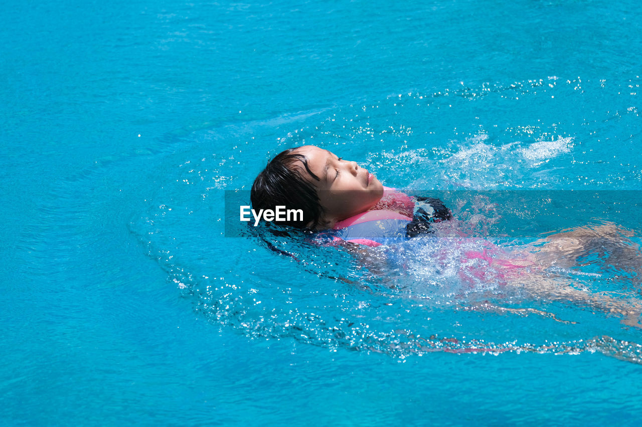 man swimming in pool