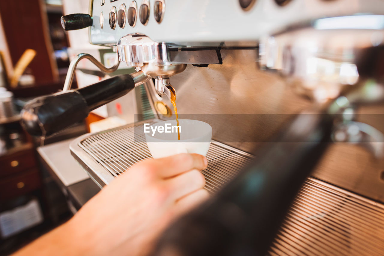 Close-up of coffee being poured in cup at cafe