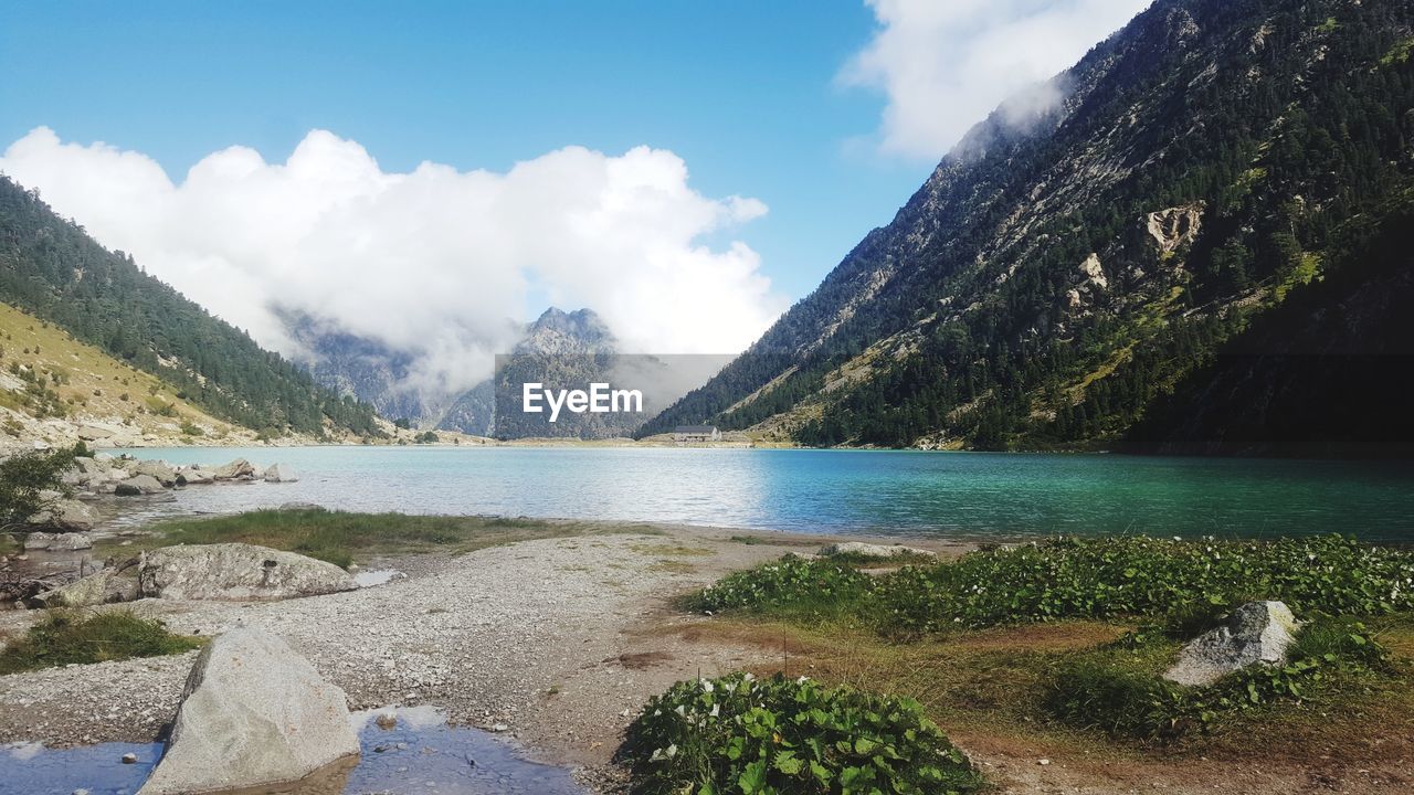 Scenic view of lake and mountains against sky