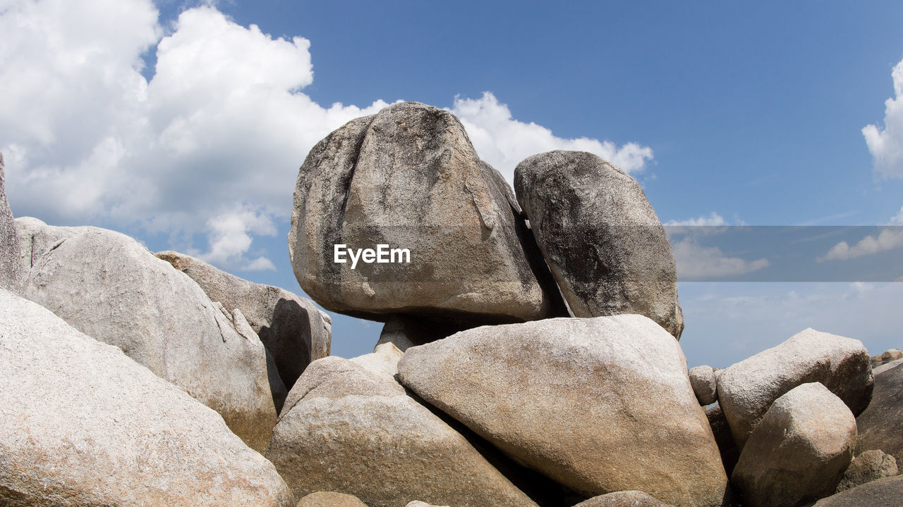 Low angle view of rocks against sky