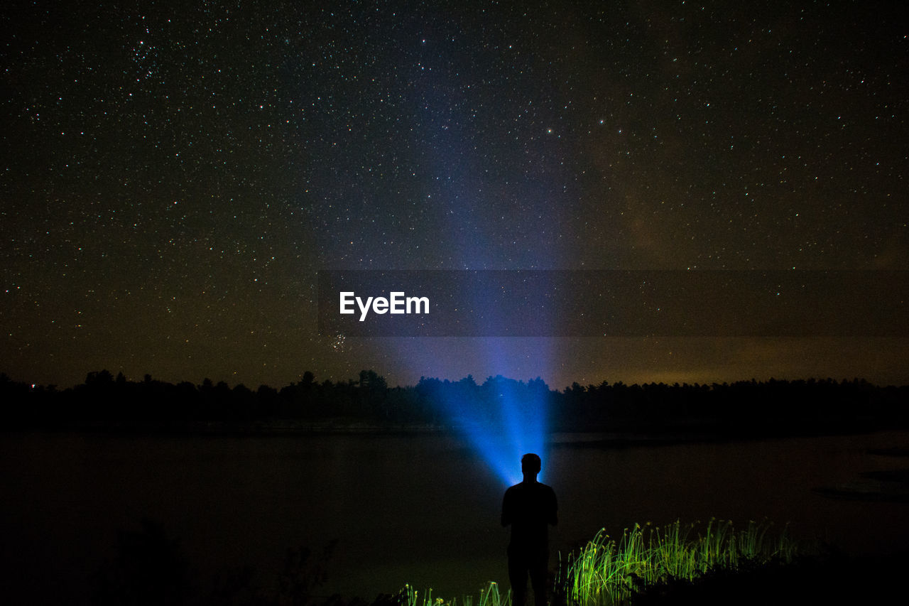 Person holding light at night