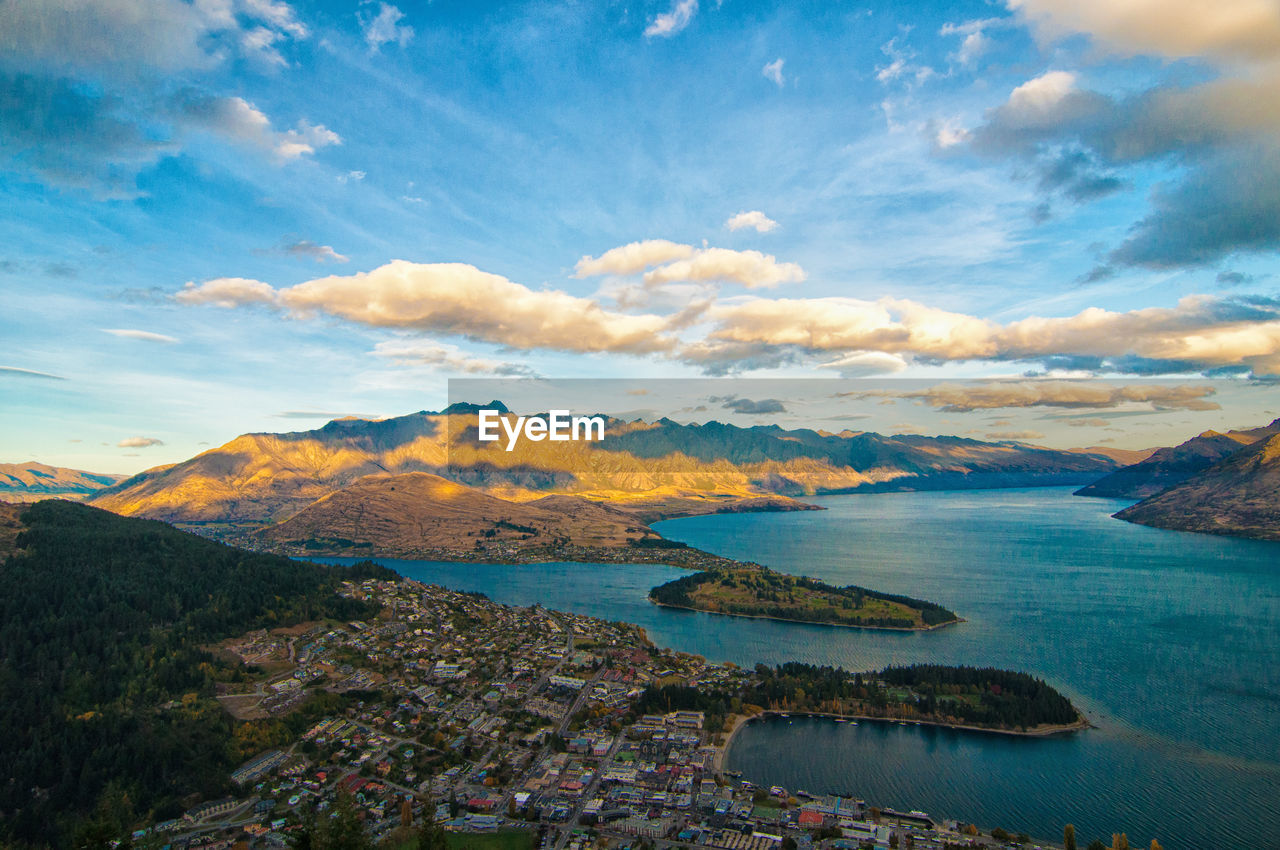 Scenic view of sea by city against sky