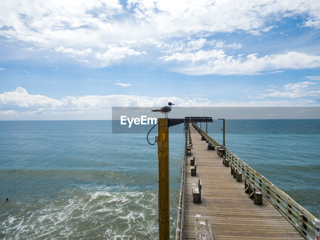 Pier over sea against sky