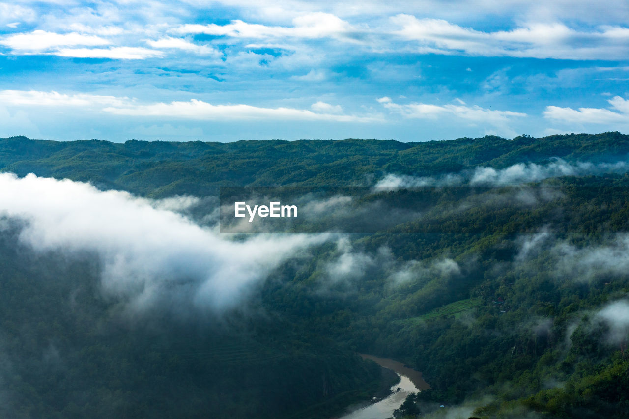 Scenic view of sea and mountains against sky