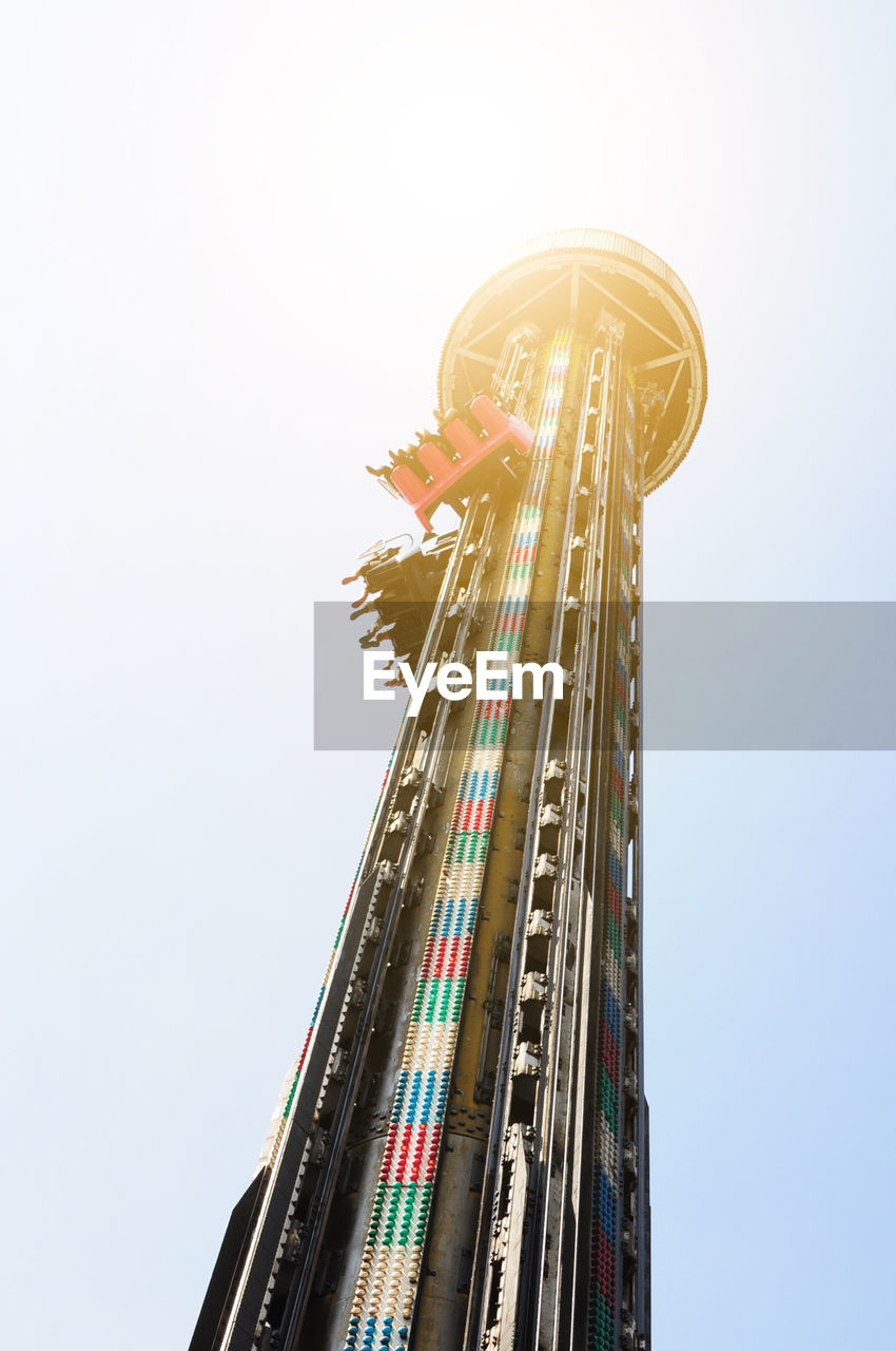 Low angle view of drop tower ride against sky