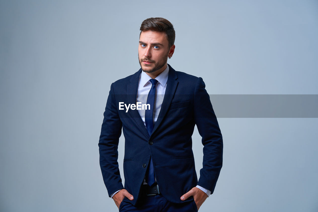 PORTRAIT OF YOUNG MAN AGAINST WHITE BACKGROUND