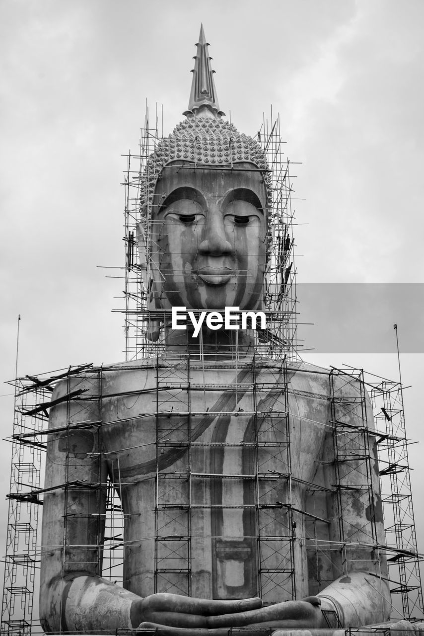 architecture, black and white, built structure, sky, monochrome, monochrome photography, religion, statue, temple, history, building exterior, travel destinations, cloud, sculpture, the past, nature, building, landmark, temple - building, belief, travel, spirituality, monument, construction industry, low angle view, outdoors, industry, day, no people, human representation, tourism, craft, business finance and industry, city, tower, place of worship