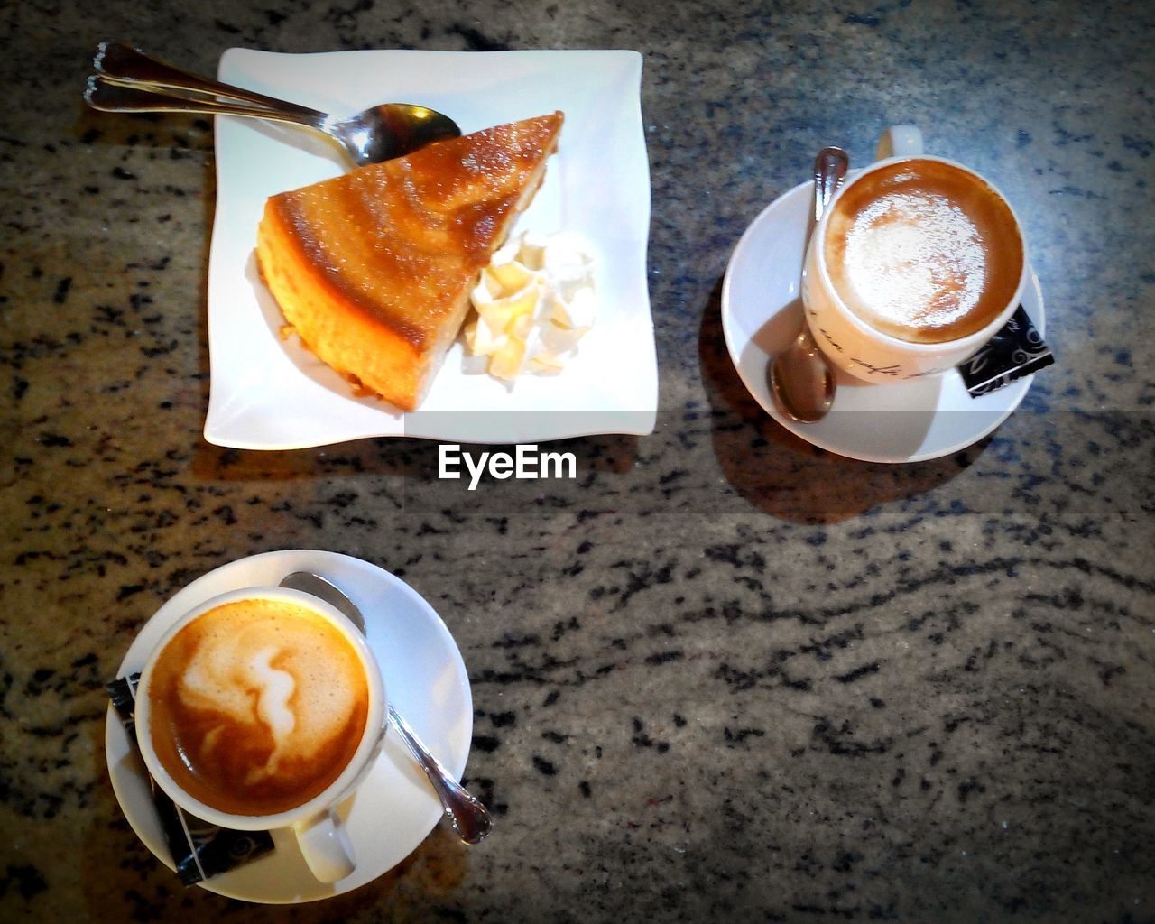 High angle view of coffee served on table with cake