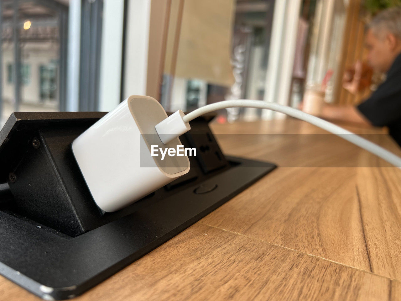 Charger is connected with the pop-up outlet on the table