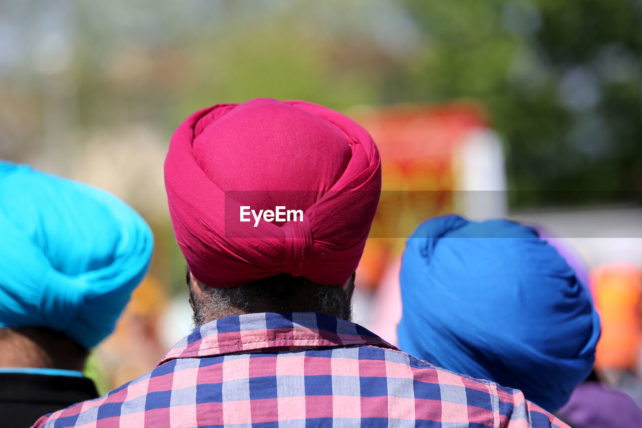 Rear view of men wearing turbans during sunny day