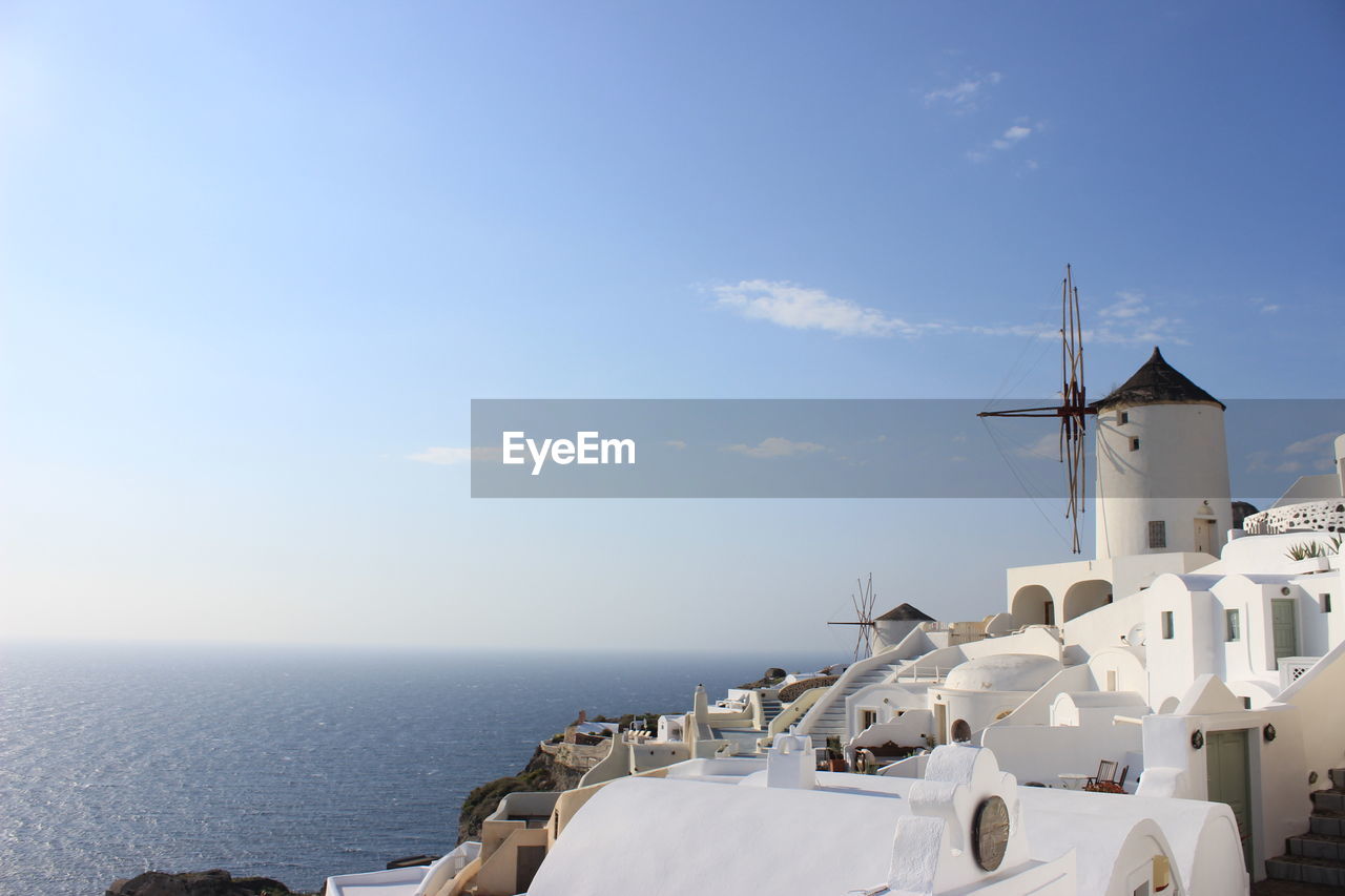 TRADITIONAL WINDMILL ON SEA AGAINST SKY