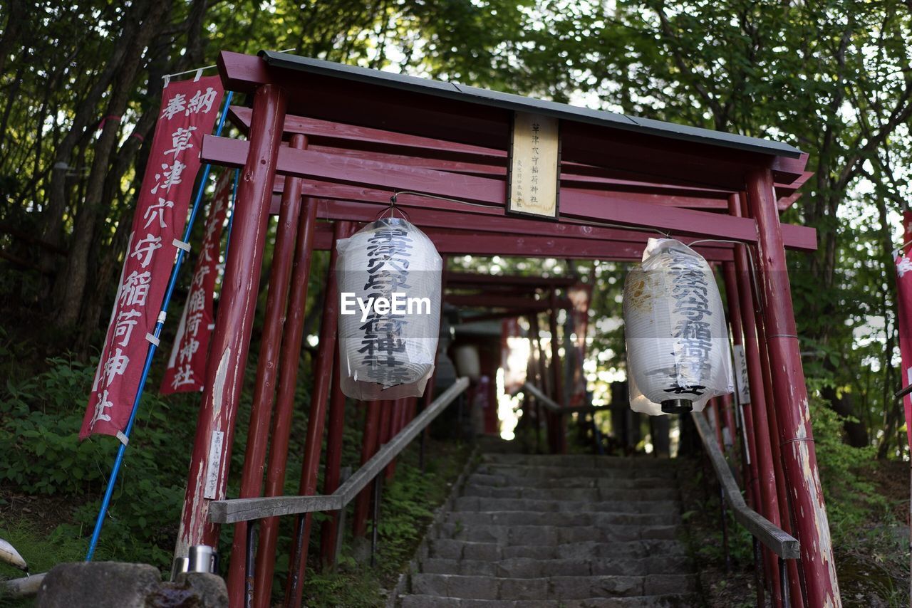 CLOTHES HANGING ON BUILDING BY TEMPLE AGAINST TREES AND BUILDINGS