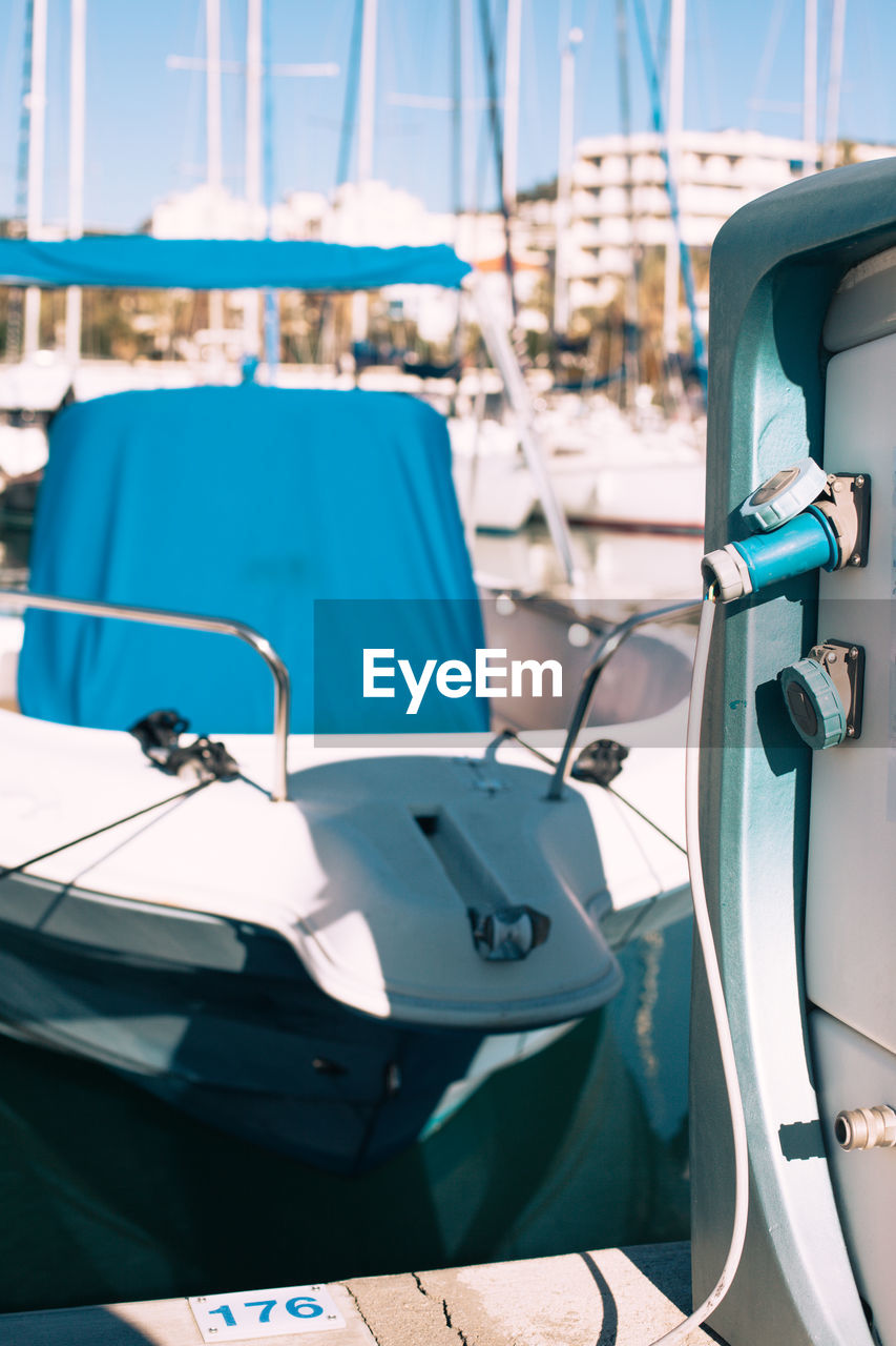 BOATS MOORED ON SEA