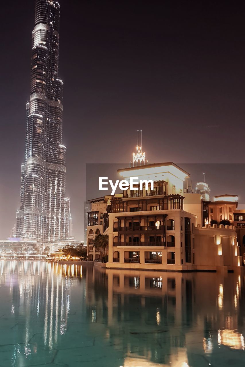 ILLUMINATED BUILDINGS AGAINST SKY