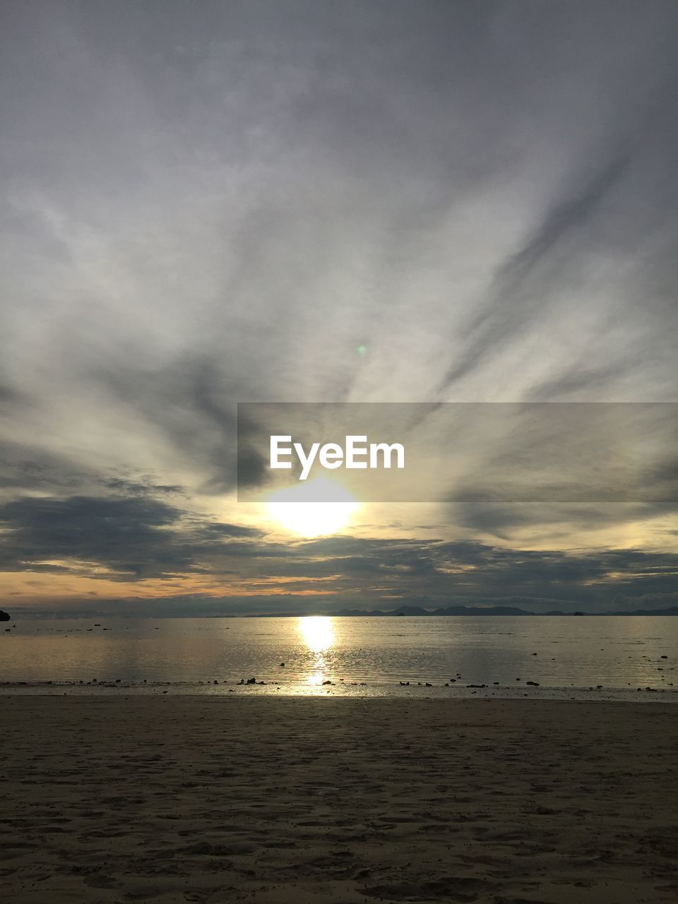 SCENIC VIEW OF BEACH AGAINST SKY DURING SUNSET