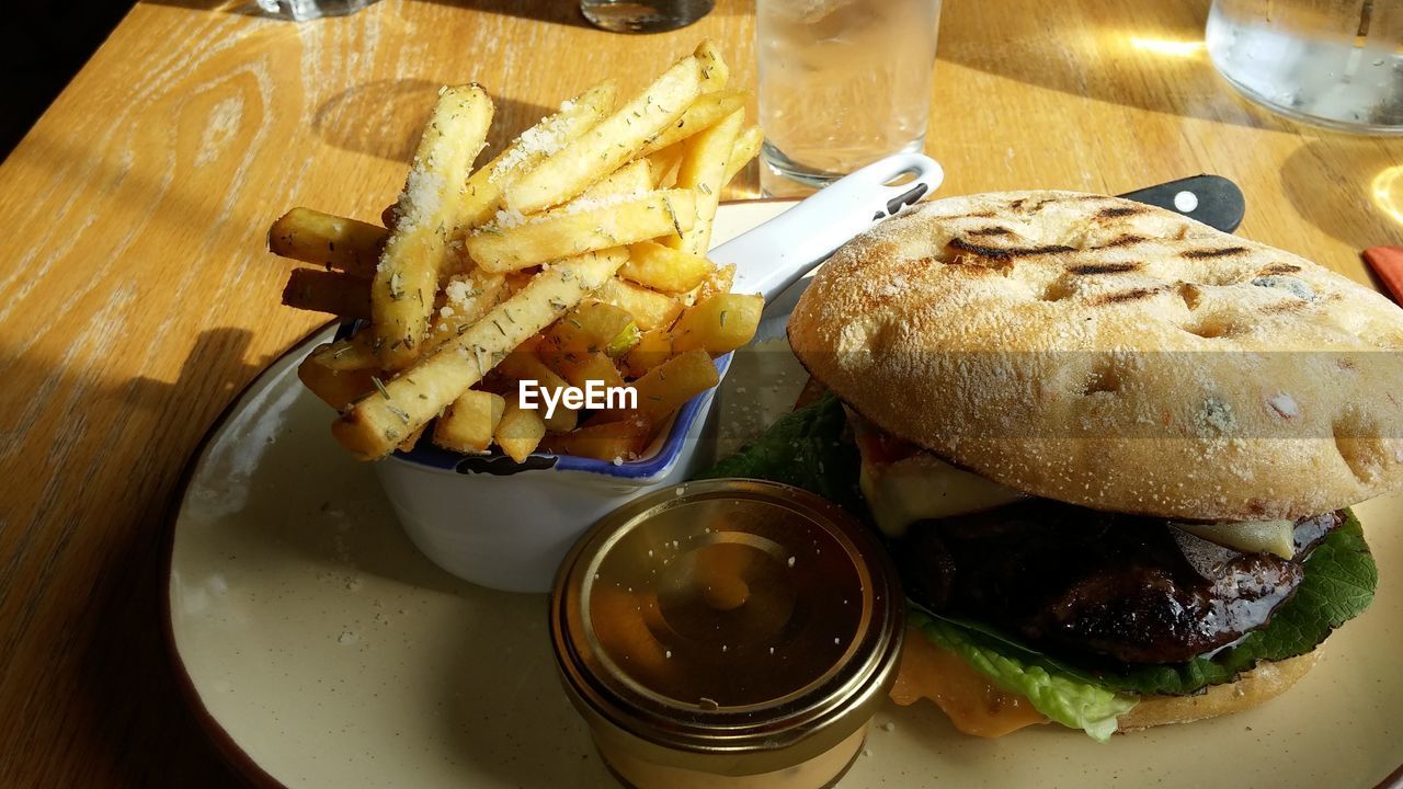 HIGH ANGLE VIEW OF MEAT AND FRIES ON TABLE