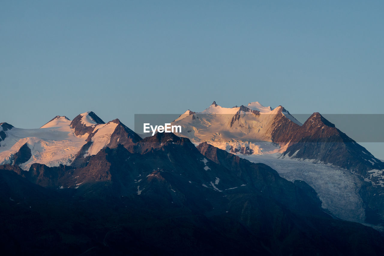 Scenic view of snowcapped mountains against clear sky