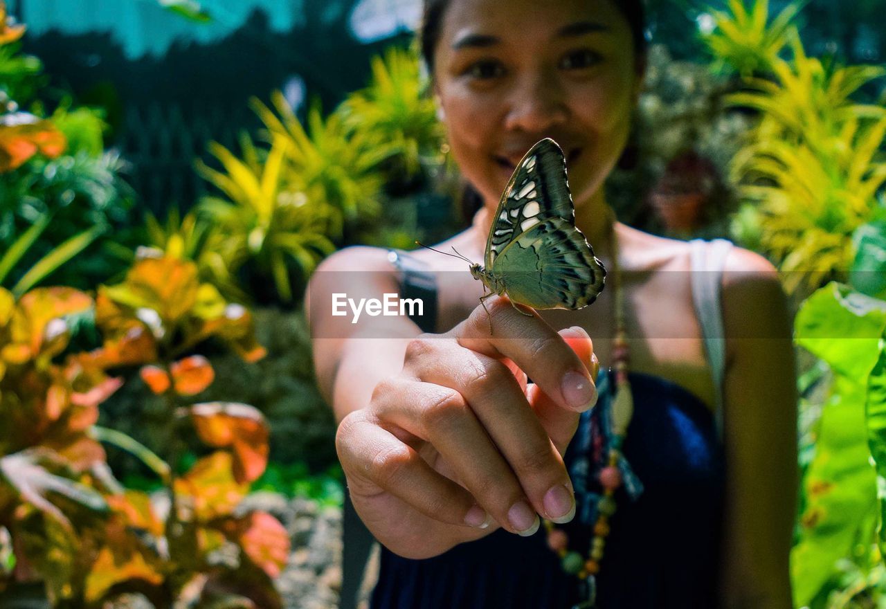 Portrait of woman with butterfly