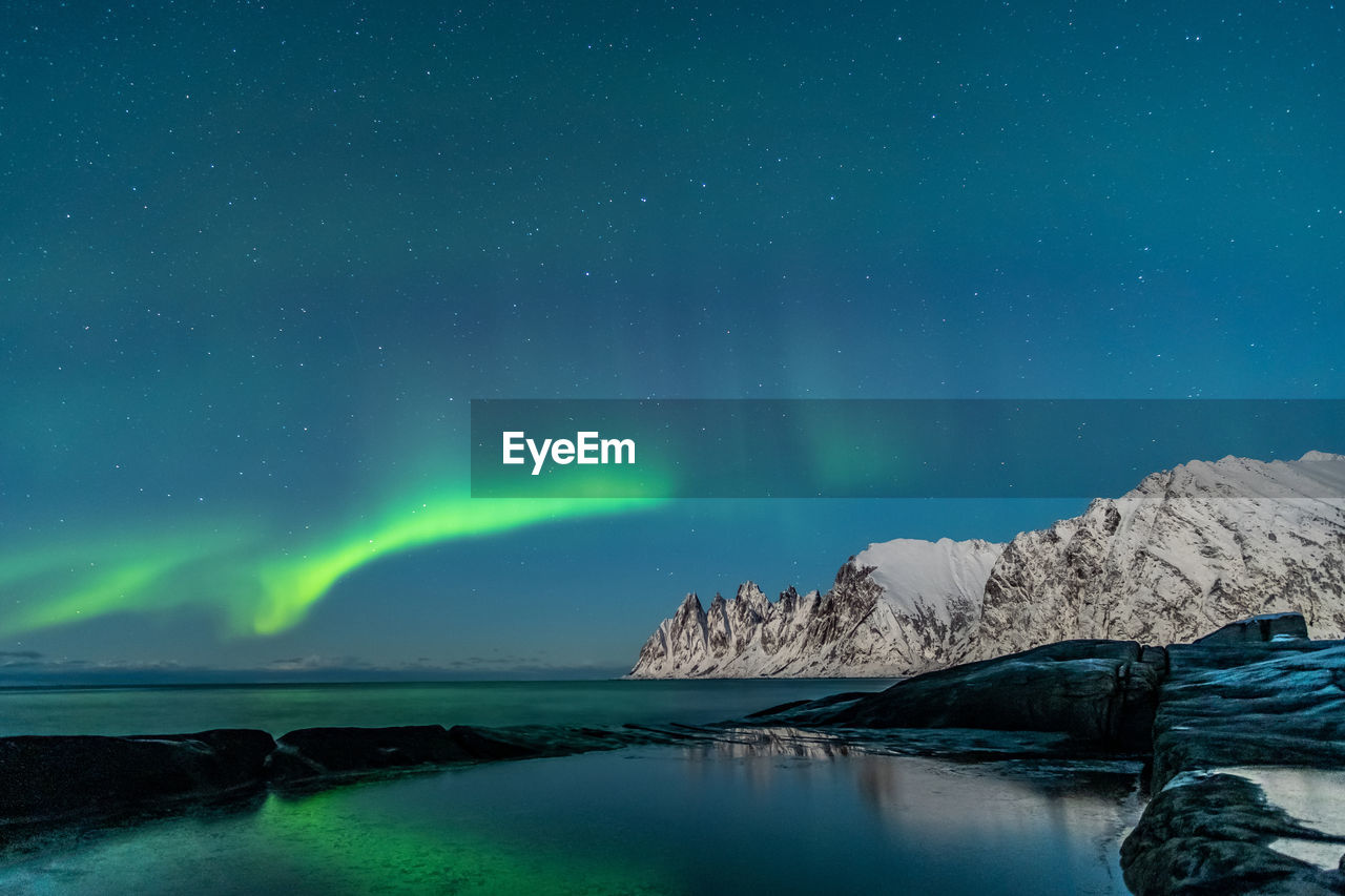 Scenic view of rock formation against sky at night