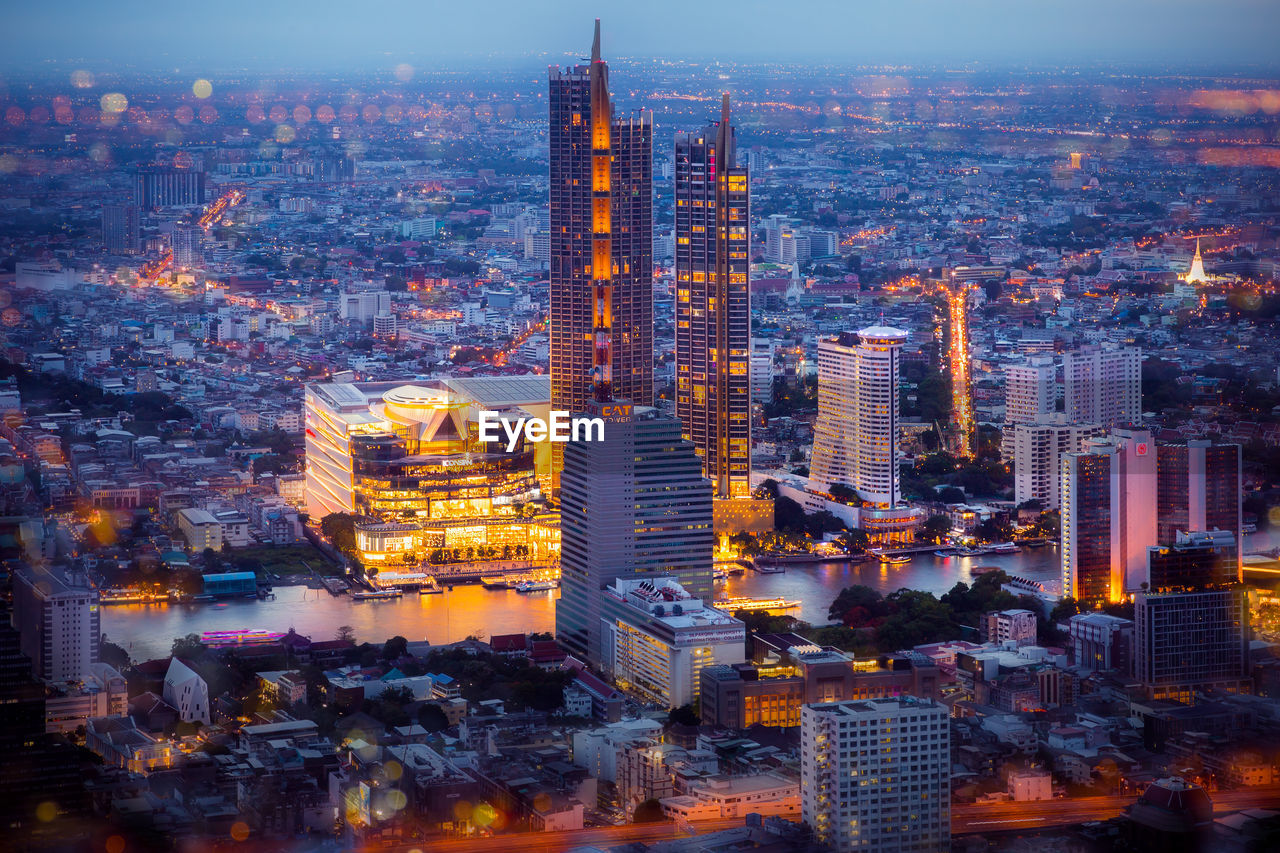 AERIAL VIEW OF CITY BUILDINGS AT DUSK