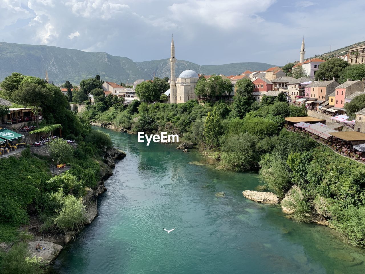 River amidst buildings in city against sky