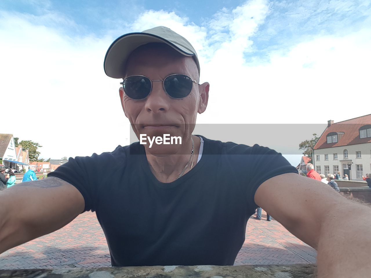 PORTRAIT OF BOY WEARING SUNGLASSES IN SKY