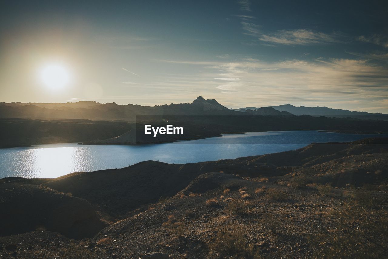 Scenic view of lake against sky during sunset