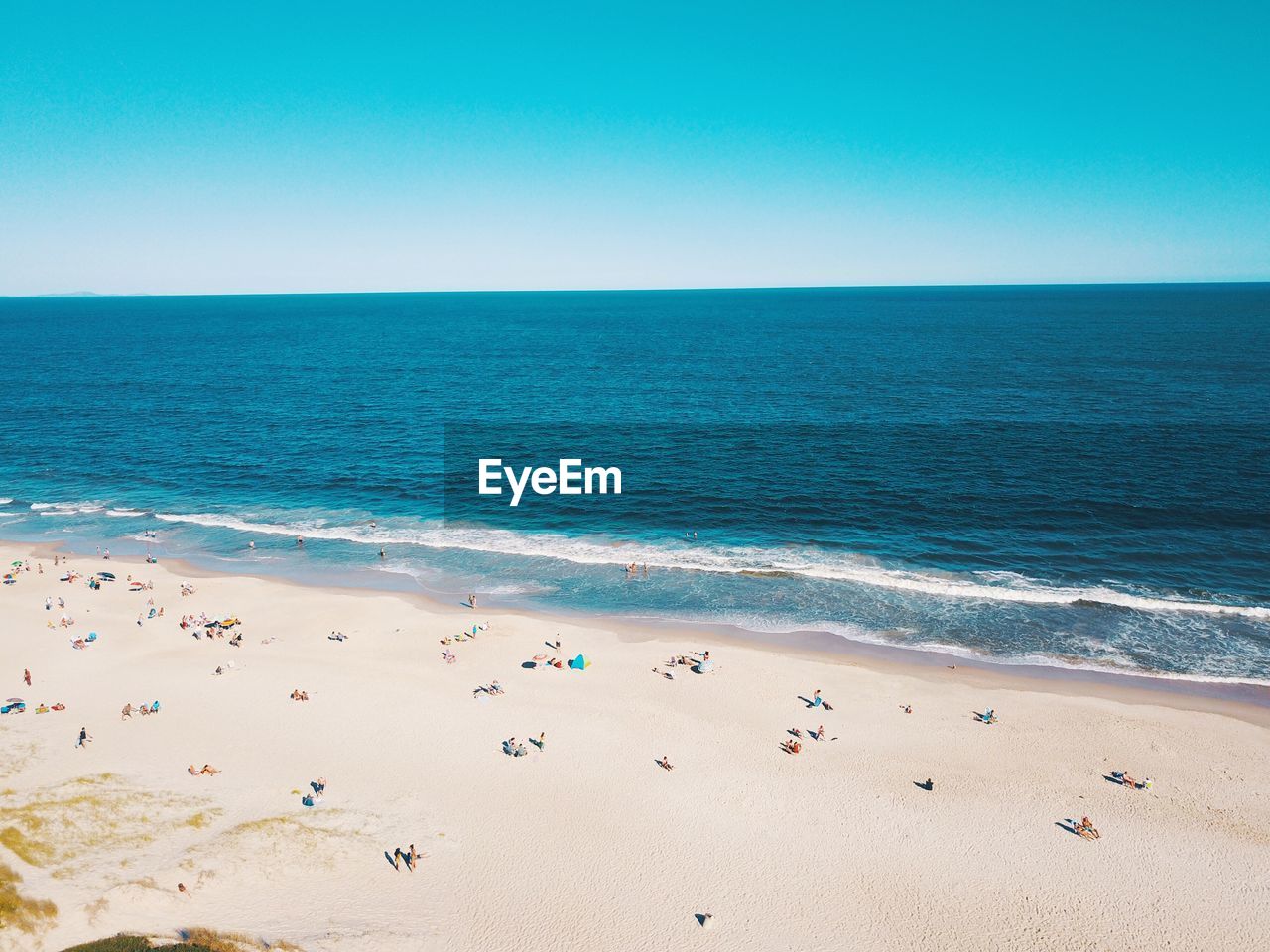 Scenic view of sea against clear blue sky