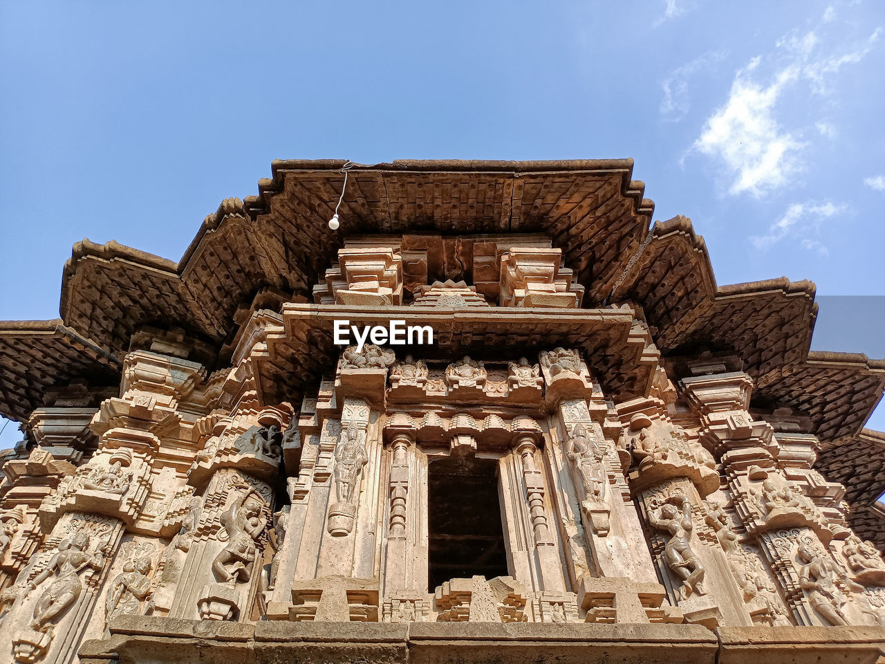 architecture, built structure, history, religion, temple, temple - building, the past, travel destinations, belief, craft, archaeological site, building exterior, building, sky, ancient, travel, ancient history, spirituality, landmark, historic site, place of worship, tourism, nature, sculpture, no people, low angle view, ruins, ancient civilization, stone material, outdoors, statue, day, blue, tradition, cloud, city, ornate, old, old ruin