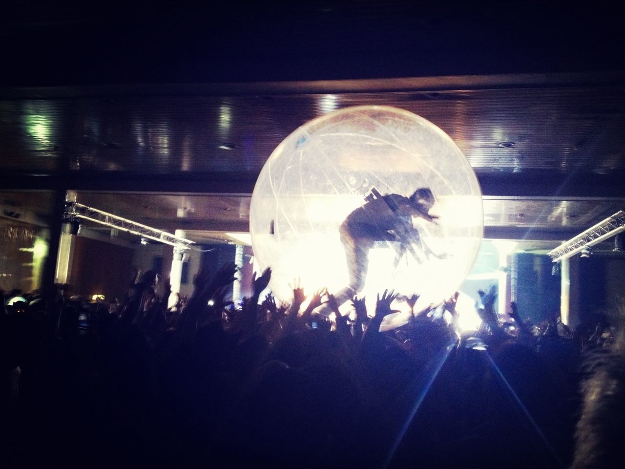 Woman in transparent ball along people at an event