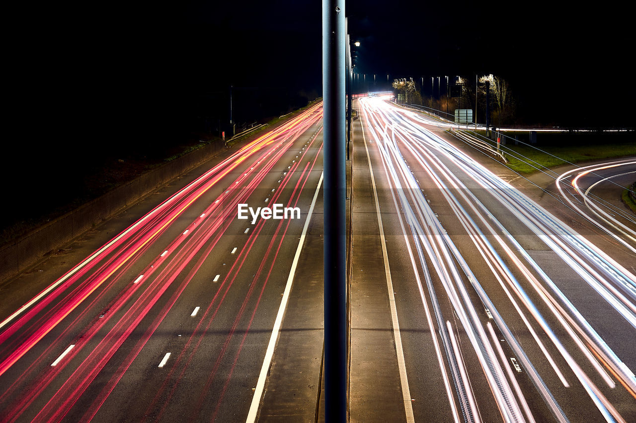 High angle view of light trails on highway at night