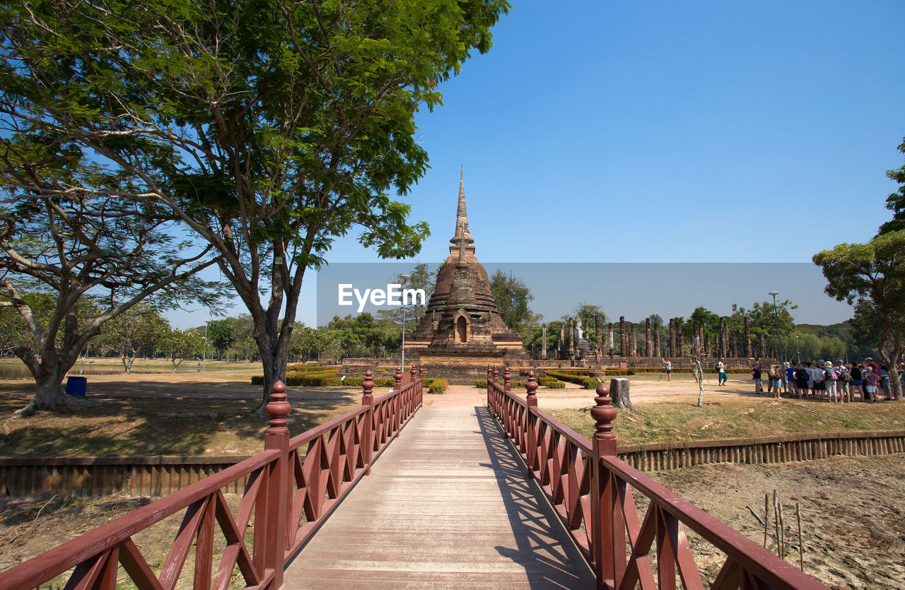 PANORAMIC VIEW OF TEMPLE AMIDST BUILDINGS AGAINST CLEAR SKY