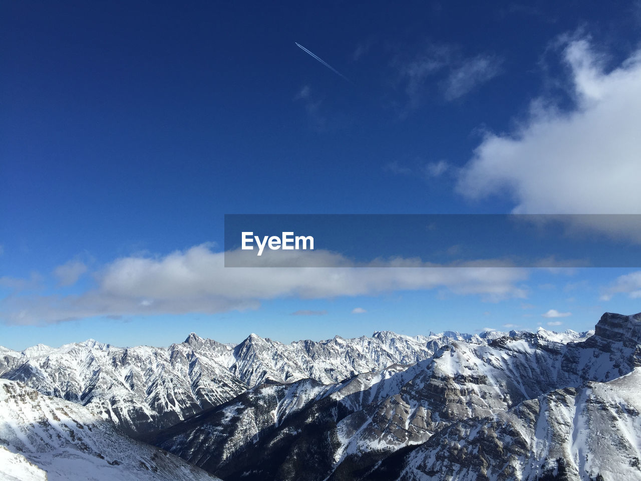 Scenic view of mountains against blue sky